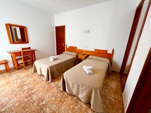 Posteľ alebo postele v izbe v ubytovaní Hostal Eden