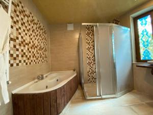 a bathroom with a tub and a shower and a sink at Kapadokya Konak in Uchisar
