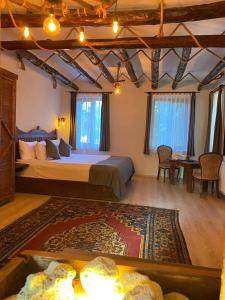 a bedroom with a large bed and a table and chairs at Kapadokya Konak in Uchisar