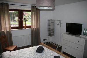 a bedroom with a bed and a tv and a window at Appartement Sto in Hannover