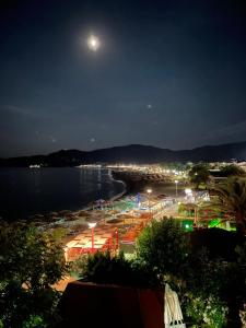 a view of a beach at night with a moon at Athos Veranda in Sarti