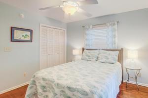 a bedroom with a bed and a ceiling fan at Goldie's Retreat in Edisto Beach +28 photos