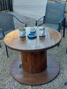a wooden table with two bowls of plants on it at Traditional old style farmhouse in Coolvally