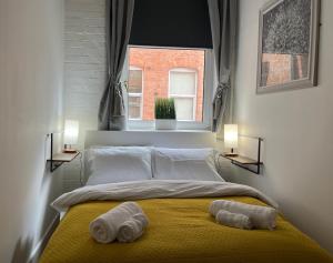 a bedroom with a bed with two towels on it at Cosy Apartment in the Heart of Leicester in Leicester