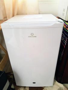 a white refrigerator sitting on the floor in a room at Dulcinea Mini House in Salinas