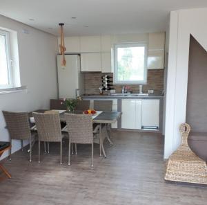 a kitchen and dining room with a table and chairs at River Casa in Ledine