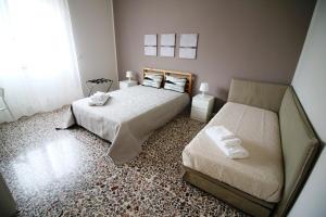 a bedroom with two beds and a window at Giuffrida Apartment Rooms in Catania