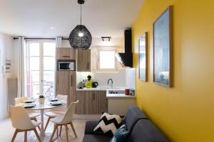 a living room with a couch and a table at ColorPop - Netflix Wifi Tout équipé - Appart Pézenas Centre in Pézenas