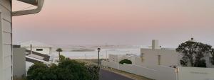 a view of the ocean from a building at Hilton Cove Beach House in Melkbosstrand