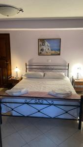 a large bed in a bedroom with two night stands at Το κατώγι in Mouresi