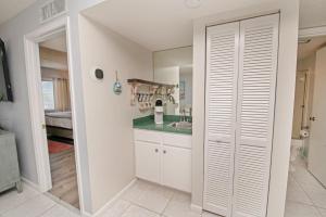 a kitchen with white cabinets and a sink at 4205 Courtyard Villa 2nd Fl N in Saint Augustine Beach +62 photos
