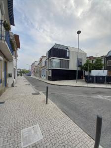 an empty street with buildings on the side of the road at Casa Aveiro Modern House in Aveiro
