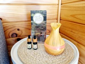 a table with two bottles of essential oils and a brush at Opononi Bliss in Opononi
