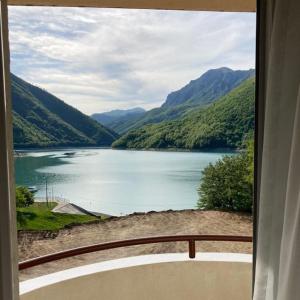 a view of a lake from a window at Zora Apartment in Plužine
