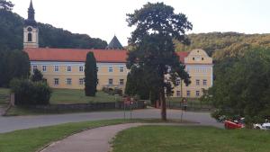 a large building with a tree in front of it at Iriški san in Irig