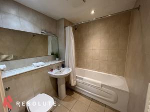 a bathroom with a sink and a tub and a toilet at Spacious 2 Bedroom Arcadian Centre with Balcony & Birmingham City Centre in Birmingham