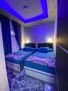 two beds in a room with a purple ceiling at أجمل شاليه فى بورتو مطروح للعائلات فقط in Marsa Matruh