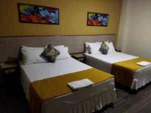 Ein Bett oder Betten in einem Zimmer der Unterkunft Hotel El Andino