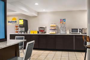 a fast food kitchen with a counter and chairs at Days Inn by Wyndham Philadelphia Convention Center in Philadelphia