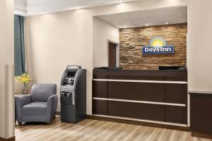 a living room filled with furniture and a television at Days Inn by Wyndham Philadelphia Convention Center in Philadelphia