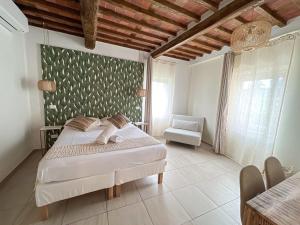 a bedroom with a bed and a chair in it at NEW! -Verderame Rooms & Suite in Lucca in Lucca