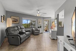 a living room with a couch and a chair at Wander Residence Condo near Fort DeSoto in Tierra Verde