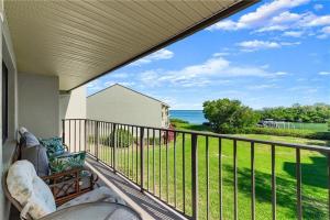 a balcony with a couch and a view of the ocean at Wander Residence Condo near Fort DeSoto in Tierra Verde