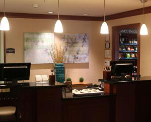 a waiting room with a hair salon with two lights at Sonesta ES Suites Fort Lauderdale Plantation in Plantation