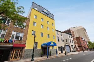 a yellow building on the side of a street at Days Inn by Wyndham Philadelphia Convention Center in Philadelphia