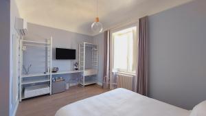 Postel nebo postele na pokoji v ubytování D-Home Ortigia