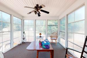 a living room with a ceiling fan and a table at Country Estates --- 15 Wagon Wheel in Ocean View