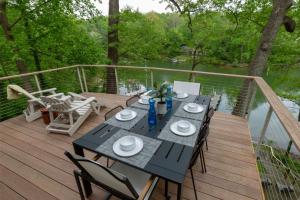 a wooden deck with a table and chairs on it at Chase Creek Retreat in Annapolis