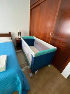 a bath tub in a room with a bed at Home Village in Vila do Bispo