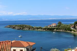 an island in the water with houses and a boat at Villa Sea View in Volos