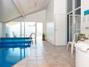 a bathroom with a swimming pool and a tub at 10 person holiday home in Juelsminde in Sønderby