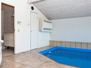 a swimming pool in a bathroom with a heater at 10 person holiday home in Juelsminde in Sønderby