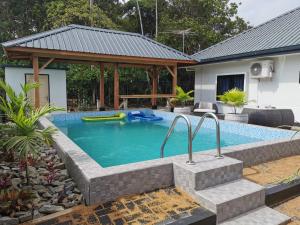 a swimming pool in the backyard of a house at Tropical appartement 2 in Paramaribo