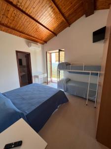a bedroom with a bed and a bunk bed gmaxwell gmaxwell gmaxwell at Agriturismo Baccanale in Prignano Cilento