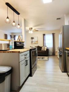 a kitchen with a counter and a living room at Venice Beach within 5 min drive, near the tennis courts and park, sleeps 5 in Nokomis
