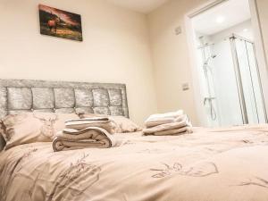 a bedroom with a large bed with a large window at Deers Leap, A modern new personal double bedroom holiday let in The Forest Of Dean in Blakeney