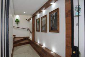 a hallway with a stairway with lights and wood floors at Hotel Casa Peregrina in Tapalpa