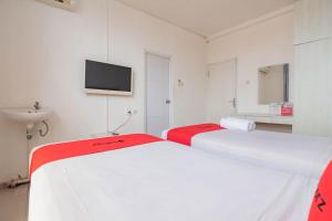 Ein Bett oder Betten in einem Zimmer der Unterkunft OYO Collection O 935 Bongo Residence