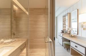 a bathroom with a shower and a sink at The Fullerton Ocean Park Hotel Hong Kong in Hong Kong