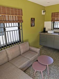 a living room with a couch and two tables at Tropical appartement in Paramaribo