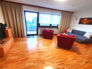 a living room with a couch and two chairs at Comfortable flat in Görwihl with balcony in Görwihl