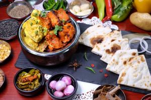 a table topped with different types of food and dips at BelAire Bangkok Sukhumvit in Bangkok