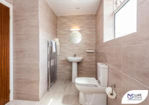 a bathroom with a toilet and a sink and a mirror at Dene Hotel in Newcastle upon Tyne +20 photos