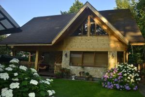 a house with flowers in front of it at Holiday home Imanta in Rīga