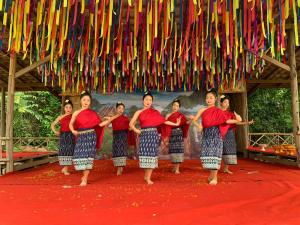 a group of women standing under a bunch of flags at Luxury Camp@Green Jungle Park in Luang Prabang +62 photos