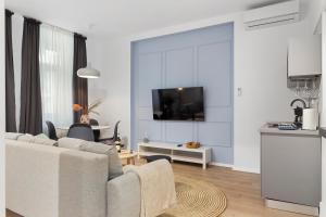 a living room with a couch and a tv at VD Boutique Apartments No 2 in Bucharest